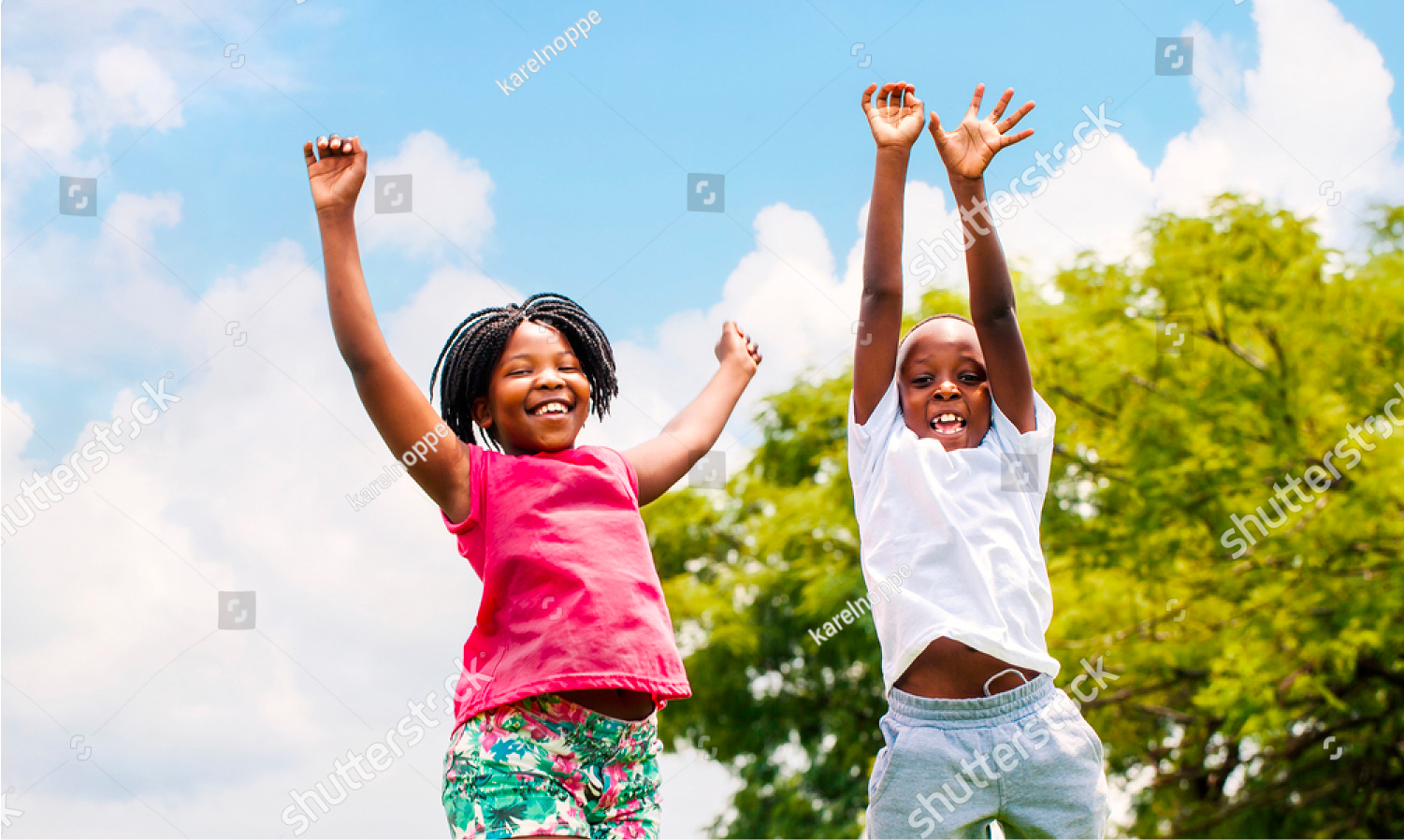 two children playing on a trampoline together