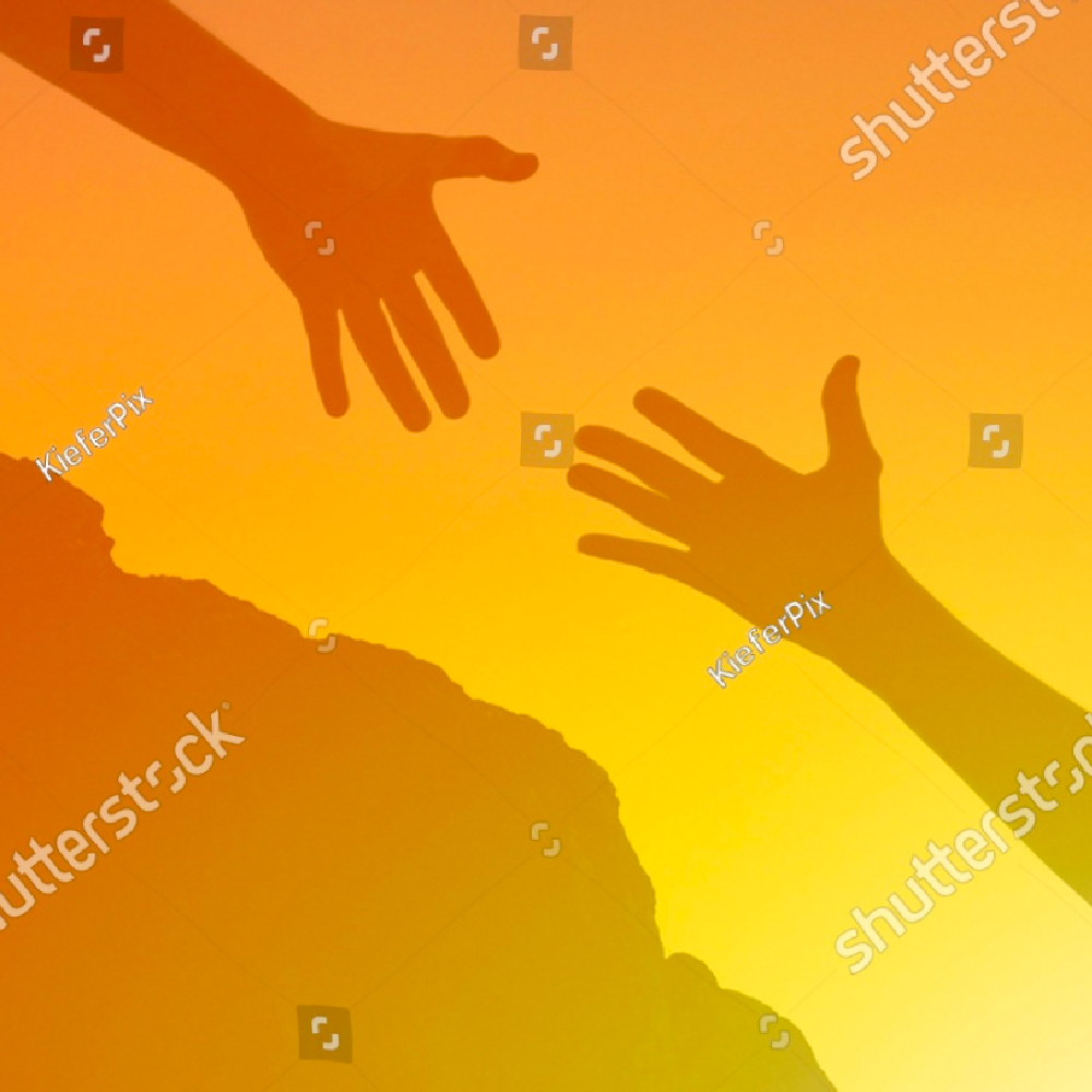 two hands at sunset reaching for each other