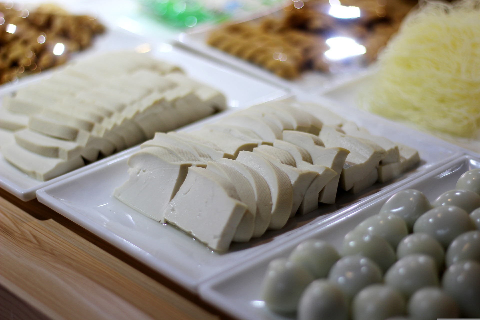 Raw tofu arranged neatly in slices on a serving plater.